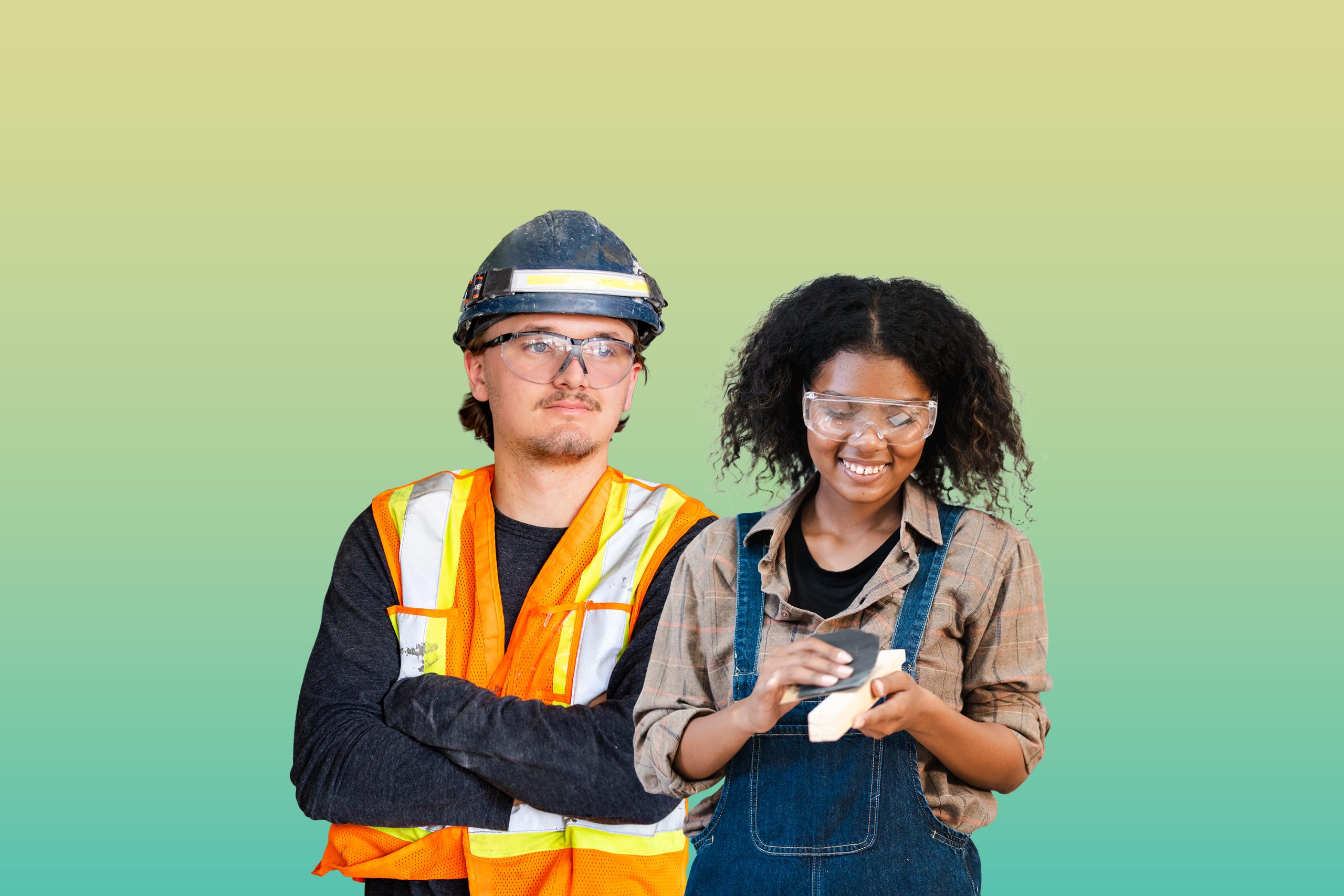 A female apprentice is sanding a wood block, and a male apprentice is standing next to her.